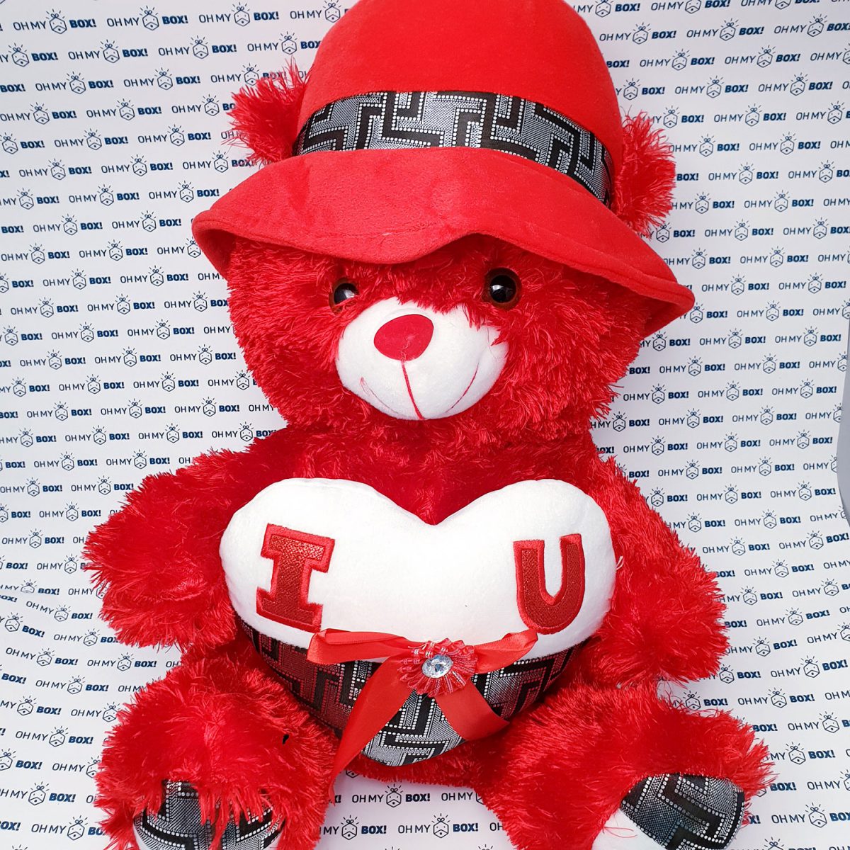 Teddy bear wearing hat and holding heart